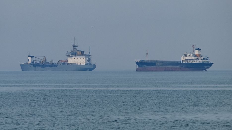 An oil tanker (R) and a cargo vessel are pictured in the Persian Gulf near the seaport city of Bushehr in Bushehr Province, southern Iran, on April 29, 2024. (Photo by Morteza Nikoubazl/NurPhoto via Getty Images)
