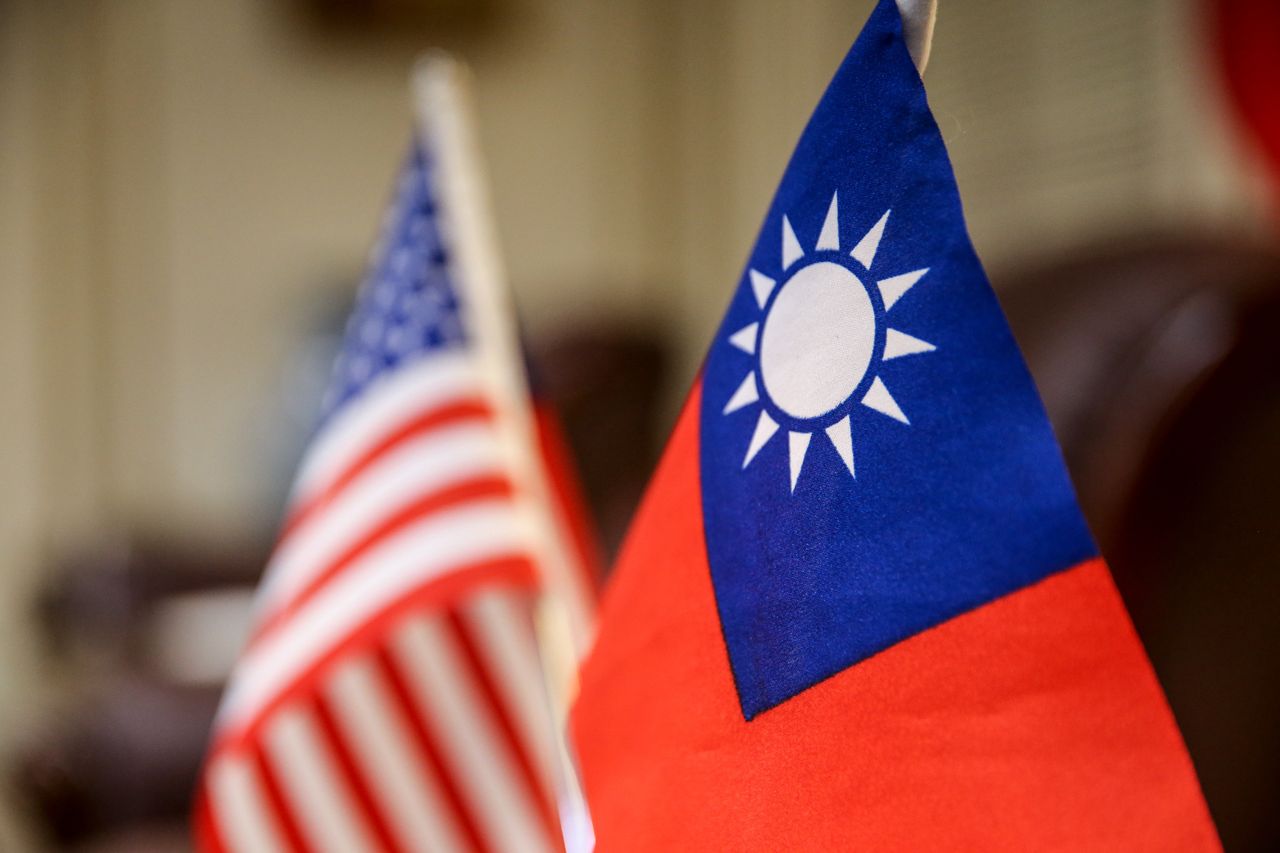 The Taiwanese flag, right, and the American flag in Taipei, Taiwan, on Thursday, Feb. 22, 2024. A delegation of US lawmakers led by Republican Mike Gallagher arrived in Taiwan, a visit that may exacerbate an already fraught relationship between the island and China. Photographer: I-Hwa Cheng/Bloomberg via Getty Images