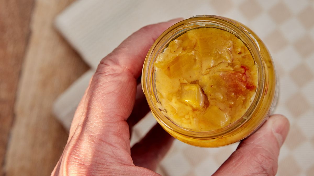 Jar of pickles
Human hand holding opened jar of pickles. Lid. Decorative kitchen towel on teak wood surface. High point of view. Light effect.
annick vanderschelden photograph