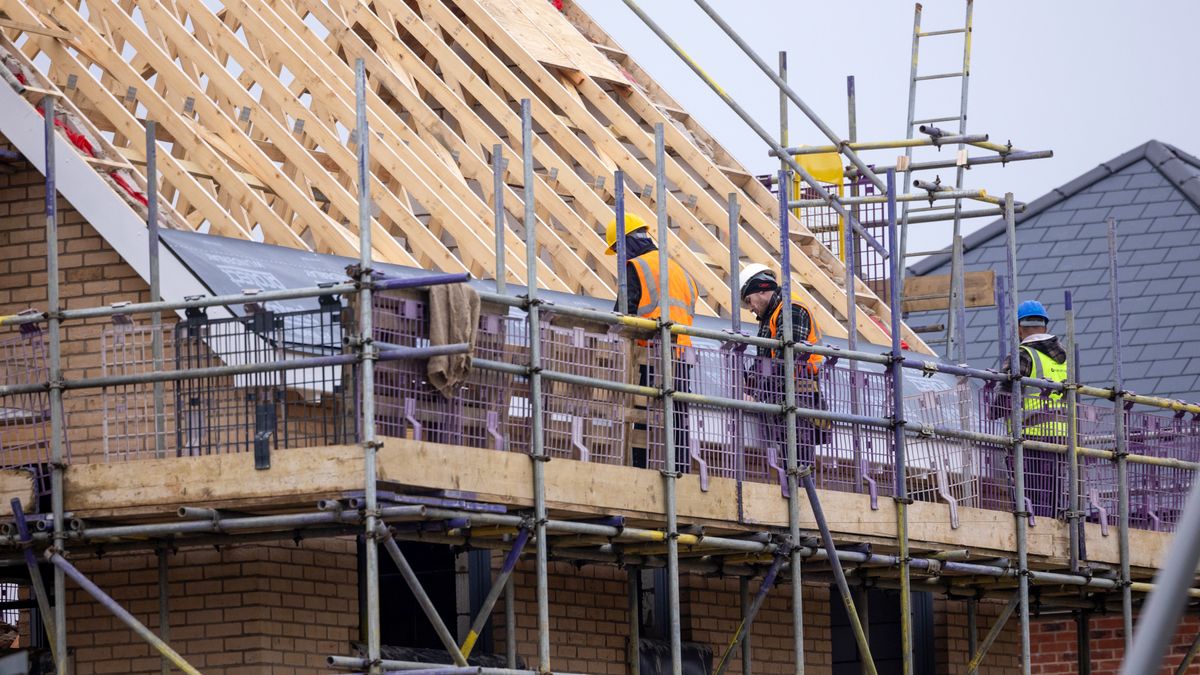 Workers lay insulation material on a roof at a Persimmon Plc residential property construction site in Braintree, UK, on Monday, March 11, 2024. Persimmon are due report their 2023 results on March 12. Photographer: Chris Ratcliffe/Bloomberg via Getty Images