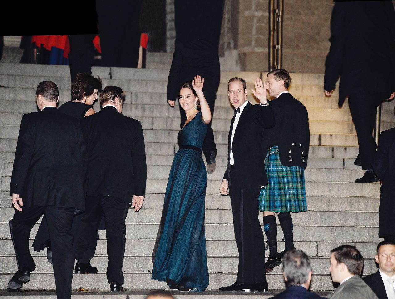 The Duke (William, Prince of Wales) and Duchess (Catherine, Princess of Wales) of Cambridge wrapped up their New York whirlwind with a proper gala Tuesday night at the Metropolitan Museum of Art to celebrate the 600th anniversary of their alma mater, the University of St. Andrews. The royal couple (carried on despite a noreaster that whipped through New York all day, leaving the city a veritable puddle. Here, with Kate dressed in Jenny Packham, they salute starry-eyed Colonists from the steps of the museum. (Photo by Steve Eichner/WWD via Getty Images)