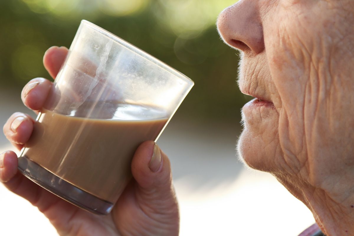 Starsza osoba pije kawę