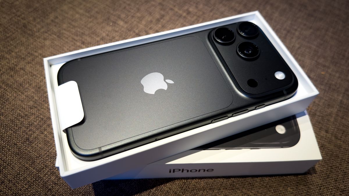 An Apple iPhone 18 Pro smartphone lies in its newly opened retail box on a table, with its rear panel, camera module and Apple logo visible, in Jozefow, Poland, on September 19, 2026. Retail sales and deliveries of the model began on September 18 following a preorder period. This photograph was taken with an Apple iPhone 16 Pro. (Photo by Mateusz Wlodarczyk/NurPhoto via Getty Images)