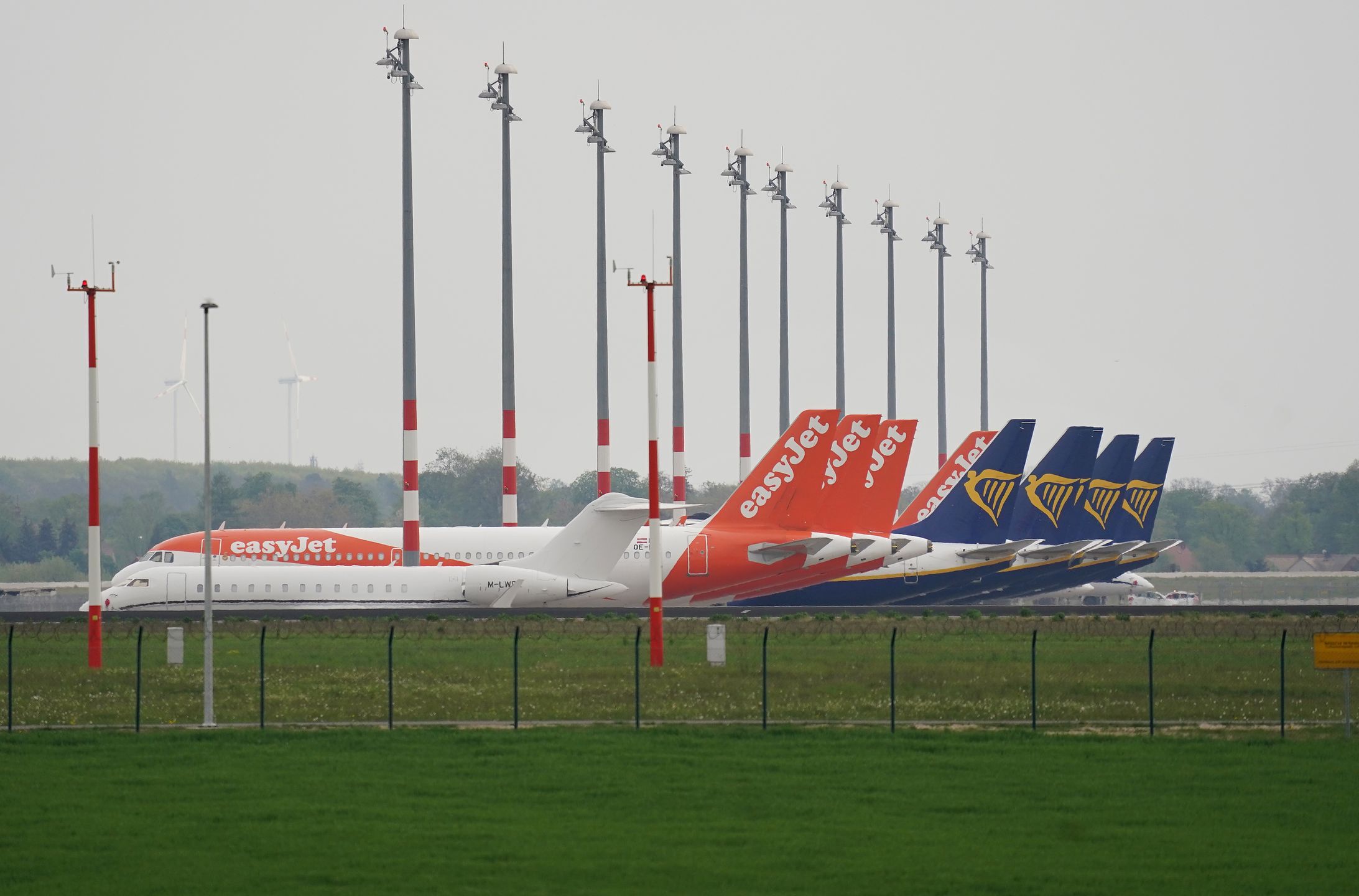 SCHOENEFELD, GERMANY - APRIL 28: Passenger planes of discount airliners EasyJet and Ryanair stand parked and not in use at Willy Brandt Berlin Brandenburg International Airport during the coronavirus crisis on April 28, 2020 in Schoenefeld, Germany. Airlines across the world are facing dire financial circumstances as global restrictions due to the pandemic continue to grind national and international travel to a near-standstill.  (Photo by Sean Gallup/Getty Images)