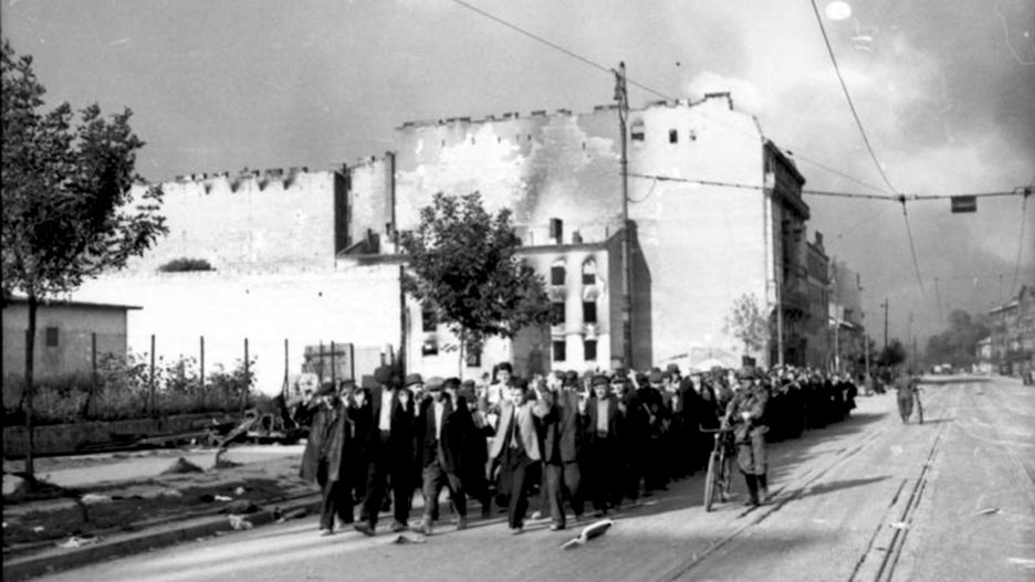 Ludność cywilna Woli prowadzona ulicą Wolską. Biały dom po lewej stronie to Wolska 56 na rogu z ulicą Płocką
