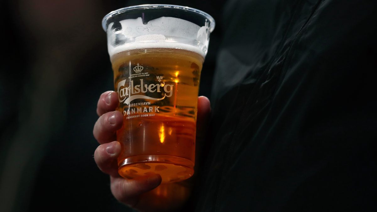 COPENHAGEN, DENMARK - FEBRUARY 20: A fan holds a pint of Carlsberg beer during the UEFA Europa League round of 16 first leg match between FC Kobenhavn and Celtic FC at Telia Parken on February 20, 2020 in Copenhagen, Denmark. (Photo by Catherine Ivill/Getty Images)
