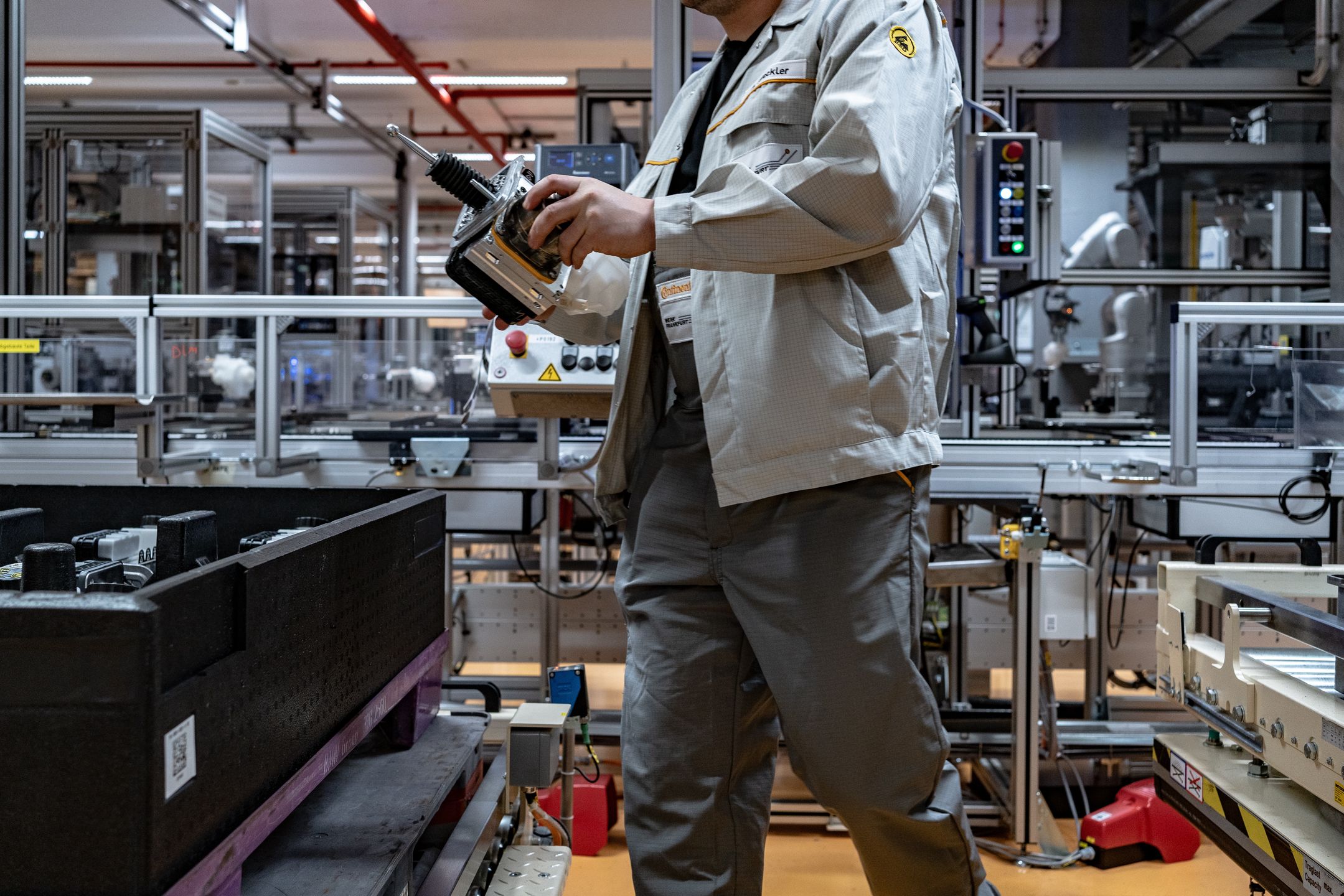 An employee places a part of an MK C2 brake system module in a container on the production line at the Continental AG manufacturing plant in Frankfurt, Germany, on Friday, March 3, 2022. The German auto supplier is scheduled to announce full year earnings on March 8. Photographer: Ben Kilb/Bloomberg via Getty Images