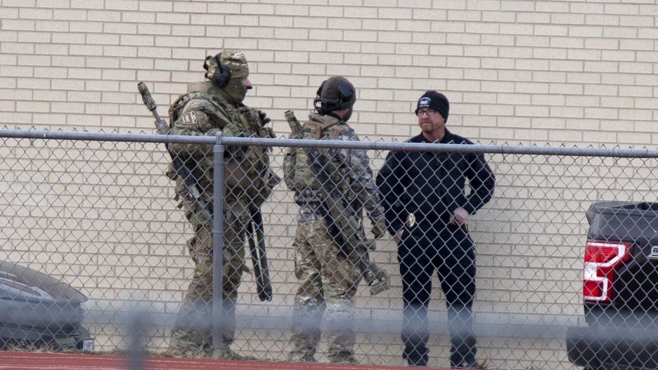 TemporaryLaw enforcement officials gather at a local school near the Congregation Beth Israel synagogue on Saturday, Jan. 15, 2022 in Colleyville, Texas. (AP Photo/Gareth Patterson)FR170364 AP