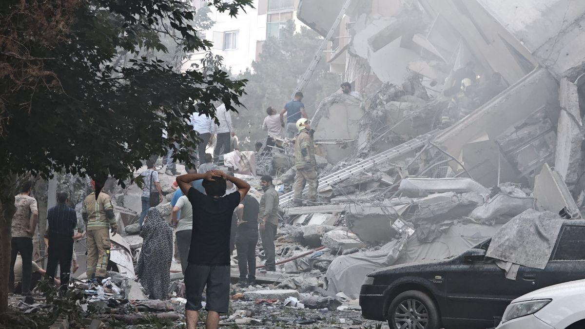 TEHRAN, IRAN - JUNE 13: People look over damage to buildings in Nobonyad Square following Israeli airstrikes on June 13, 2025 in Tehran, Iran. Iran's three top military generals were killed in the attacks that also targeted nuclear and military facilities, according to published reports. Israel described the strikes as preemptive to keep Iran from obtaining nuclear weapons, the reports said.  (Photo by Majid Saeedi/Getty Images)
