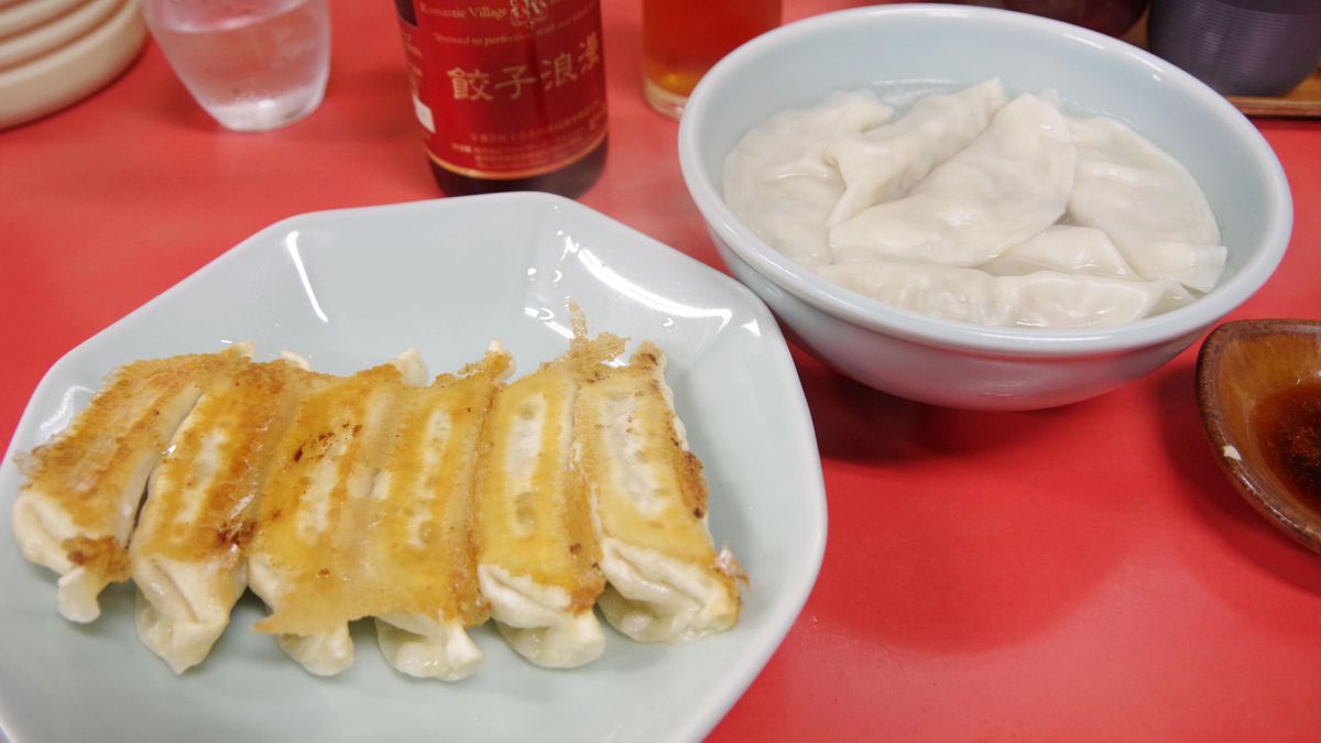Photo taken on Nov. 5, 2017, shows pan-fried "gyoza" dumplings (L) and boiled dumplings served at Utsunomiya-Minmin, a gyoza restaurant in Utsunomiya, Tochigi Prefecture, north of Tokyo. (Photo by Kyodo News via Getty Images)