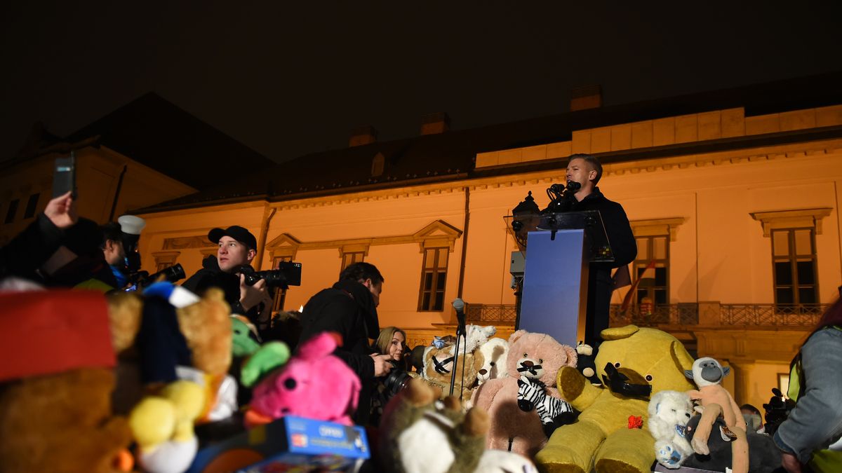 Peter Magyar speaks about the protest in Budapest, Hungary, in front of the Prime Minister's office on December 13. The stage is lined with children's toys, donated by supporters, and paintings of children are projected onto the Office of the President of Hungary. The protest comes after a report surfaces about the foster care system. (Photo by Balint Szentgallay/NurPhoto via Getty Images)