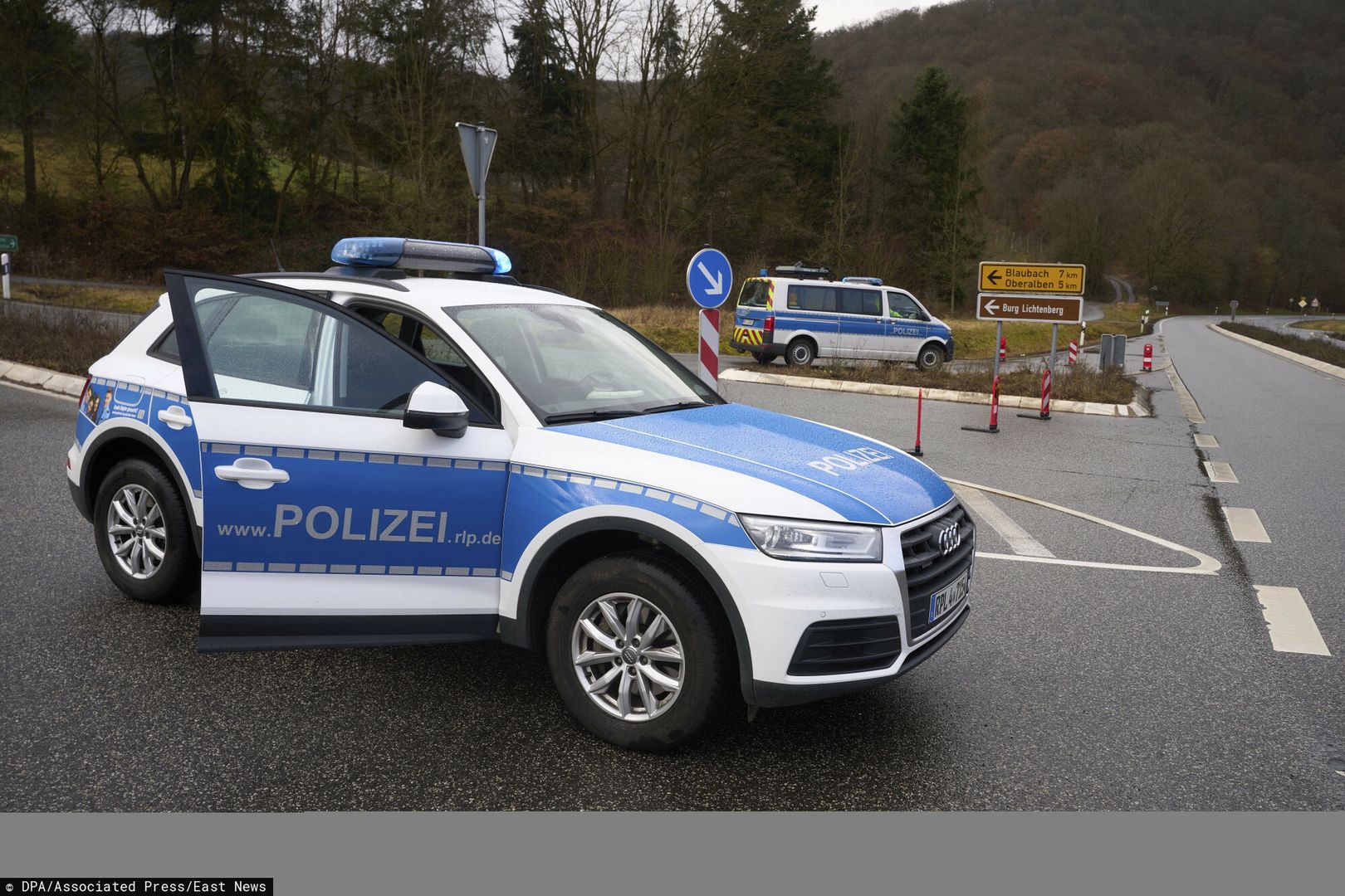 TemporaryPolice officers block the access road to the scene where two police officers were shot during a traffic stop near Kusel, Germany, Monday, Jan. 31, 2022. Police say two officers have been shot dead while on a routine patrol in western Germany. Police in Kaiserslautern said the shooting happened during a traffic check near Kusel at about 4:20 a.m. on Monday. They said that the perpetrators fled but police had no description of them, the car they used or what direction they fled in. Police called on drivers in the Kusel area not to pick up hitchhikers and warned that at least one suspect is armed. (Thomas Frey/dpa via AP)DPA