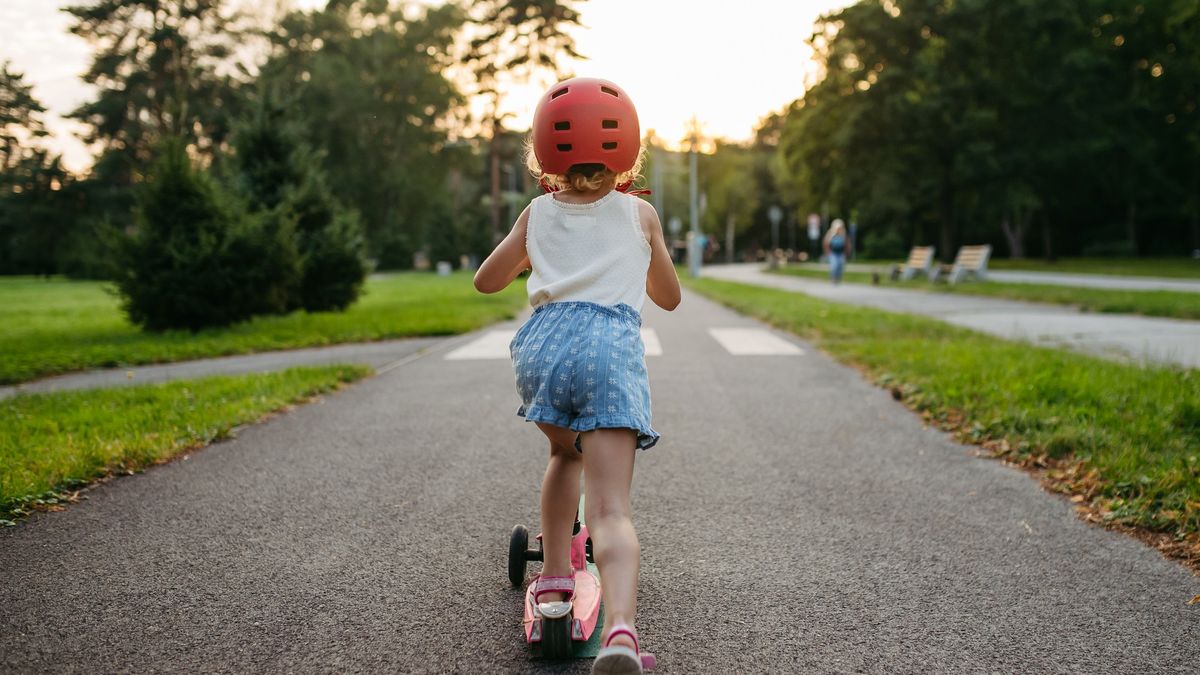 Rear view of cute girl with helmet riding scooter on bike path in the city during sunset.
Rear view of cute girl with helmet riding scooter on bike path in the city during sunset.
Halfpoint Images