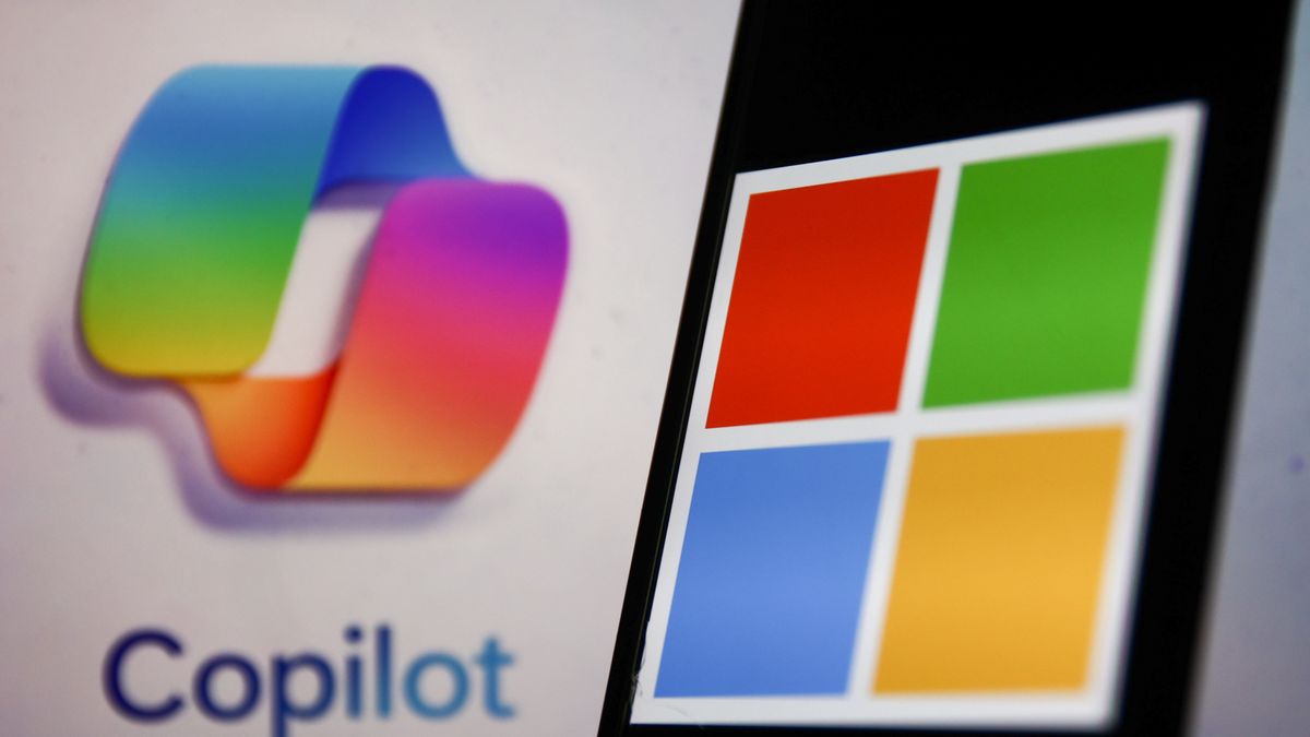 Copilot logo displayed on a laptop screen and Microsoft logo displayed on a phone screen are seen in this illustration photo taken in Krakow, Poland on October 30, 2023. (Photo by Jakub Porzycki/NurPhoto via Getty Images)
