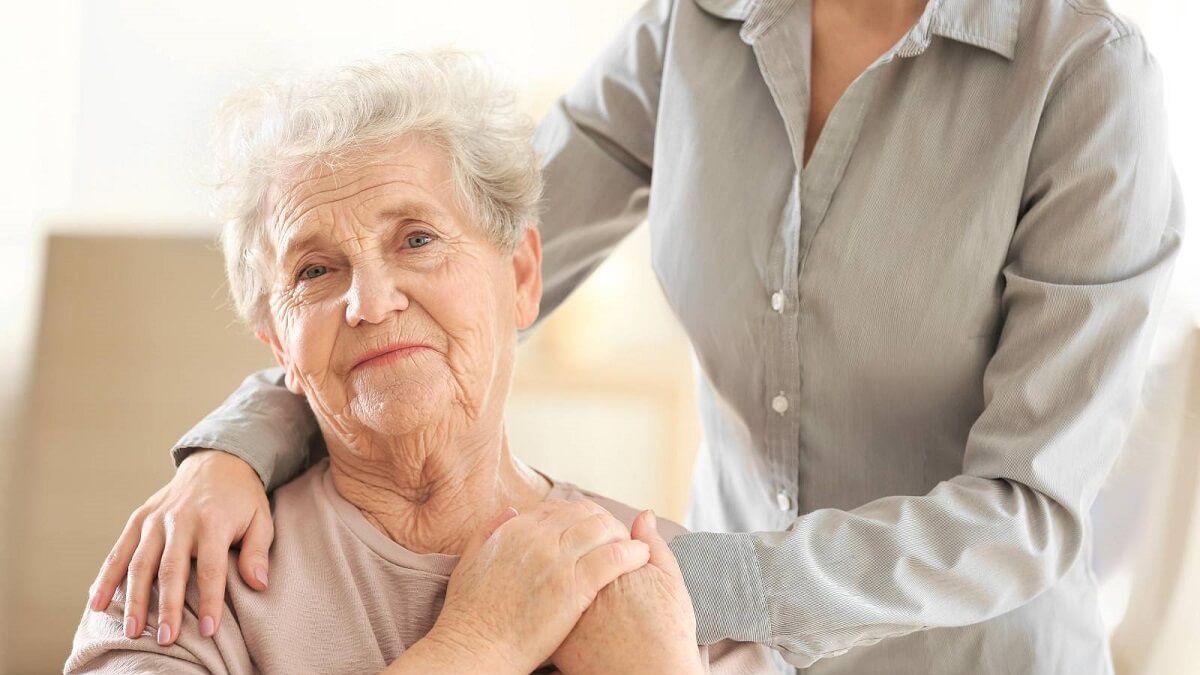 Young girl hugging old woman