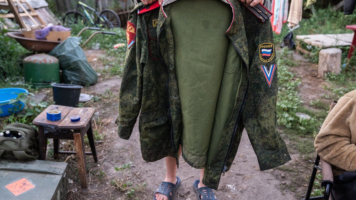 SUMY OBLAST, UKRAINE - AUGUST 16: Ukrainian soldier shows the uniform of the Russian Cossack troops with the 'V' chevron, one of the symbols of the Russian invasion, which was found on street in Sudzha on August 16, 2024 in Sumy Oblast, Ukraine. The fighting in the Kursk Oblast began on August 6, 2024, when the Armed Forces of Ukraine crossed the Russian-Ukrainian border near the city of Sudzha and began to advance deep into Russian territory, and in a few days took control of dozens of settlements in Kursk region. (Photo by Taras Ibragimov/Suspilne Ukraine/JSC "UA:PBC"/Global Images Ukraine via Getty Images)