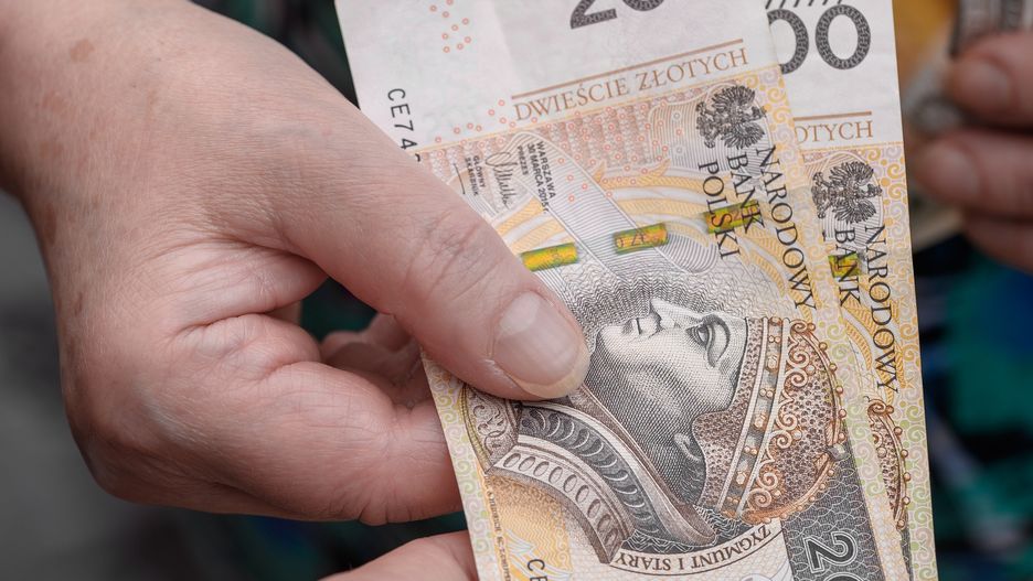 Older woman giving someone money, Polish cash PLN
Pawel Kacperek