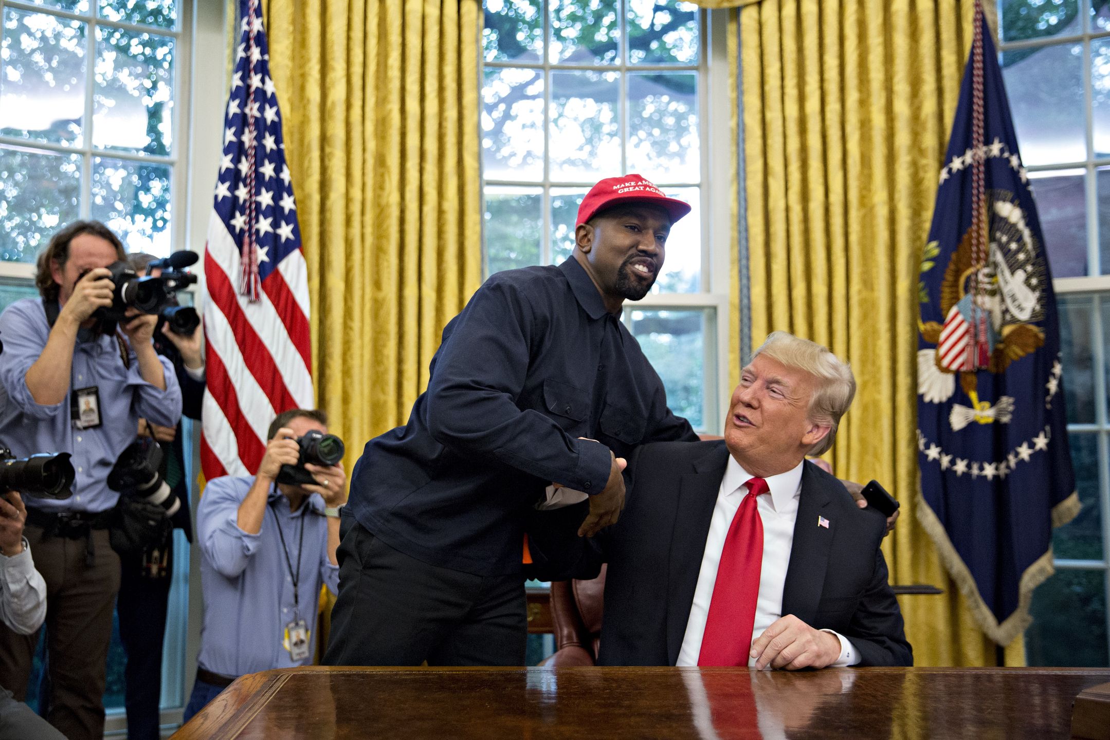 Kanye West Meets President Trump In The Oval Office Of The White HouseRapper Kanye West, left, shakes hands with U.S. President Donald Trump during a meeting in the Oval Office of the White House in Washington, D.C., U.S., on Thursday, Oct. 11, 2018. West, a recording artist and prominent Trump supporter, is at the White House to have lunch with the president and to meet with presidential son-in-law and senior adviser Jared Kushner who has spearheaded the administrations efforts overhaul the criminal justice system. Photographer: Andrew Harrer/Bloomberg via Getty ImagesBloomberg2017USPOLITICS, U.S.A., Americas, USA, US, Politics, Government, Business Finance and Industry, Washington