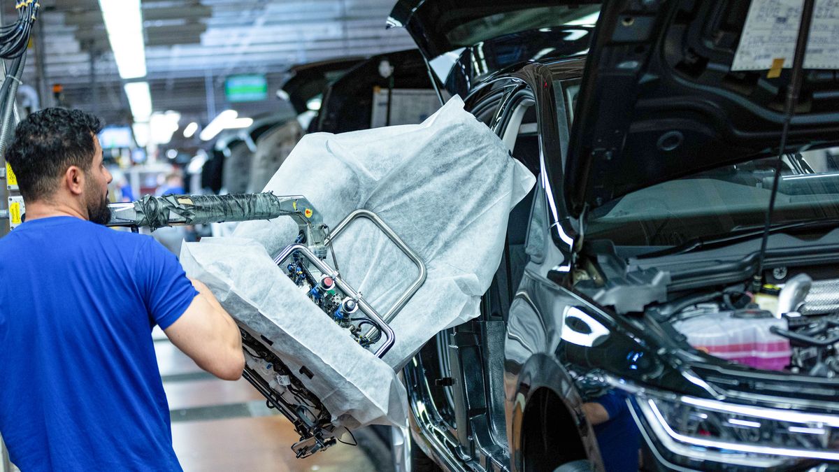 A worker fits a seat inside a VW Golf on the assembly line at the Volkswagen AG factory in Wolfsburg, Germany, on Thursday, May 23, 2024. Auto sales in Europe rose 12% in April as manufacturers including Volkswagen AG and Renault SA benefited from robust demand for plug-in and conventional cars in several major markets. Photographer: Krisztian Bocsi/Bloomberg via Getty Images