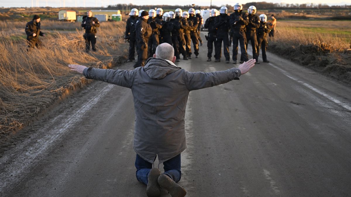 ERKELENZ, GERMANY - JANUARY 08: An activist clashes with riot police at the settlement of Luetzerath next to the Garzweiler II open cast coal mine on January 8, 2023 near Erkelenz, Germany. Police are preparing to evict environmental activists who have occupied the abandoned Luetzerath settlement. The activists are seeking to prevent Luetzerath's demolition that will make way for an expansion of the Garzweiler coal mine. Governmental authorities have approved the demolition and the coal mine expansion, while at the same time announcing an accelerated phase out of coal-fired energy production in the state of North Rhine-Westphalia by 2030. Other nearby settlements that were also slated for demolition will now be spared, though critics point out that Germany has sufficient energy production capacity and does need the coal lying beneath Luetzerath. (Photo by Sascha Schuermann/Getty Images)