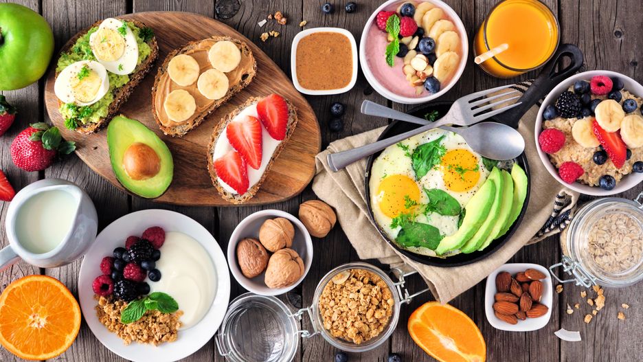 Healthy breakfast table scene with fruit, yogurts, oatmeal, smoothie, nutritious toasts and egg skillet. Top view over a wood background.
breakfast, border, healthy, table, scene, setting, background, w