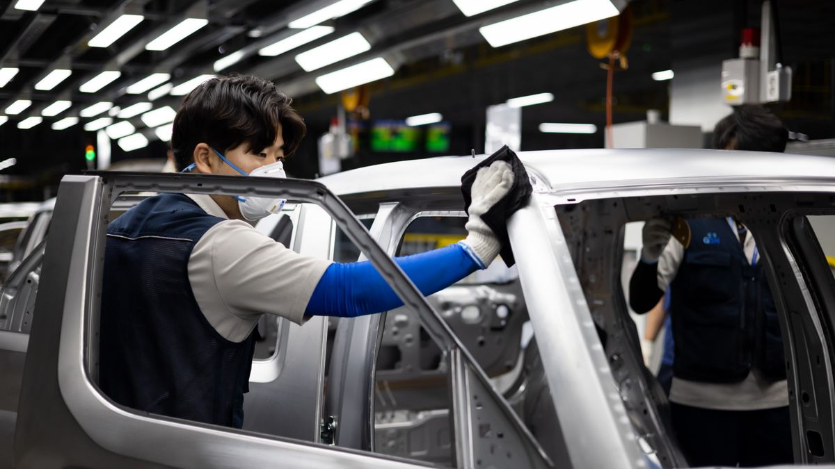 An employee wipes a body frame of a Hyundai Motor Co. Casper mini sport utility vehicle (SUV) on the production line at the Gwangju Global Motors (GGM) factory in Gwangju, South Korea, on Wednesday, Oct. 13, 2021. Gwangju Global Motors started production of Casper from September and aims to produce about 70,000 vehicles annually, according to the company. Photographer: SeongJoon Cho/Bloomberg via Getty Images