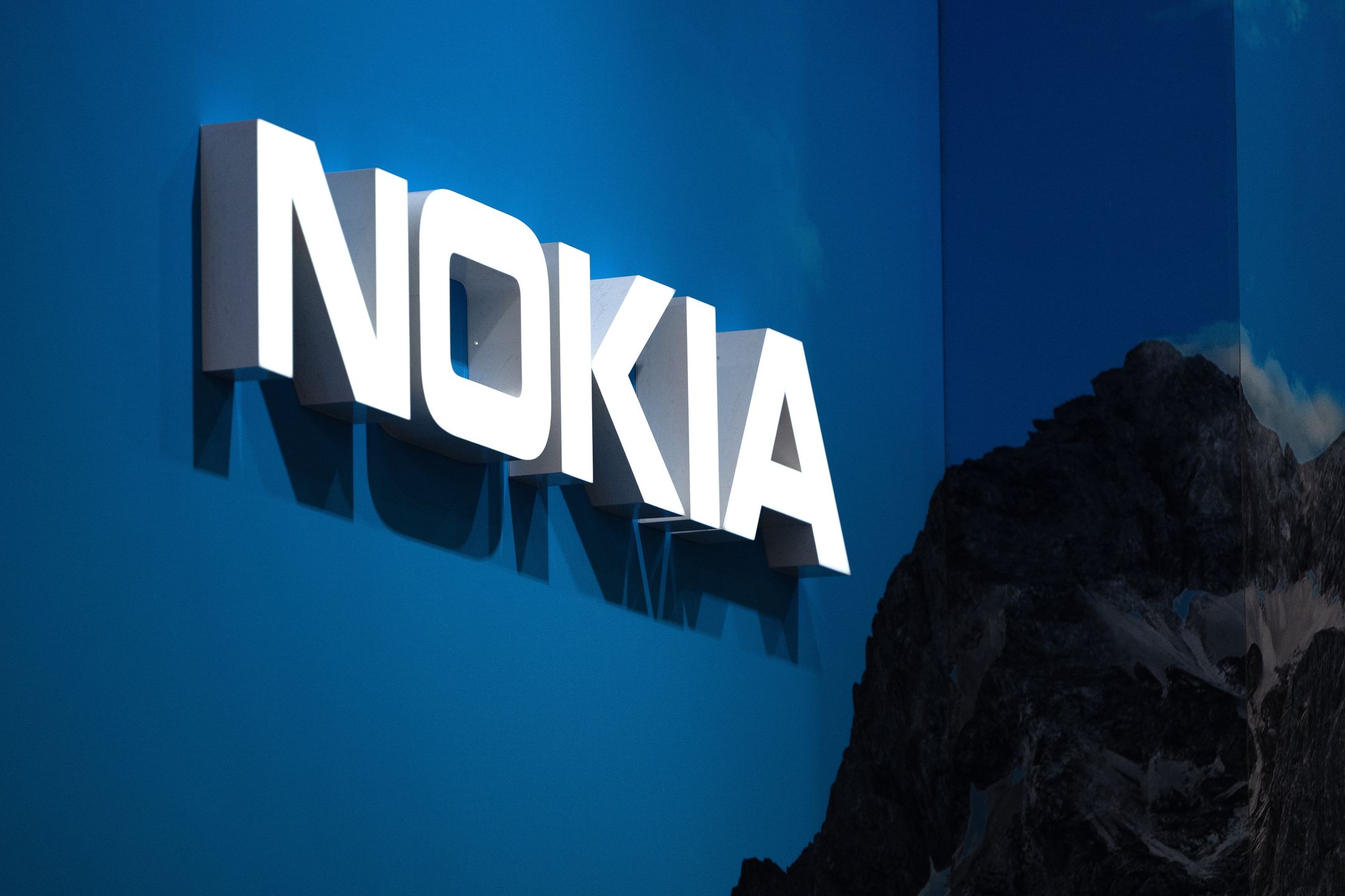 BARCELONA, SPAIN - FEBRUARY 28: A logo sits illuminated outside the Nokia booth at the SK telecom booth on day 1 of the GSMA Mobile World Congress on February 28, 2022 in Barcelona, Spain. The annual Mobile World Congress hosts some of the world's largest communications companies, with many unveiling their latest phones and wearables gadgets like foldable screens.  (Photo by David Ramos/Getty Images)