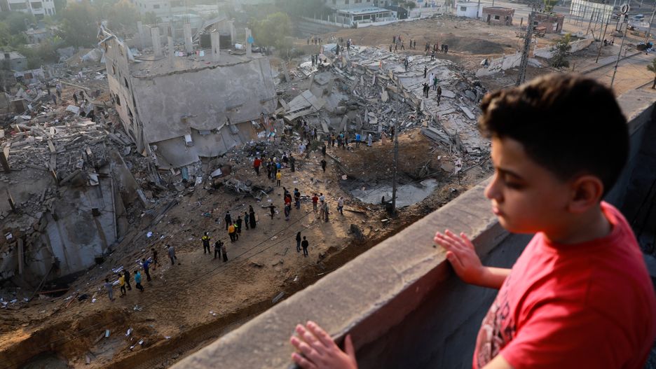 A Palestinian boy looks at ruins of buildings which were destroyed in Israeli air strikes amid a flare-up of Israeli-Palestinian violence, in the northern Gaza Strip May 13, 2021.  (Photo by Majdi Fathi/NurPhoto via Getty Images)