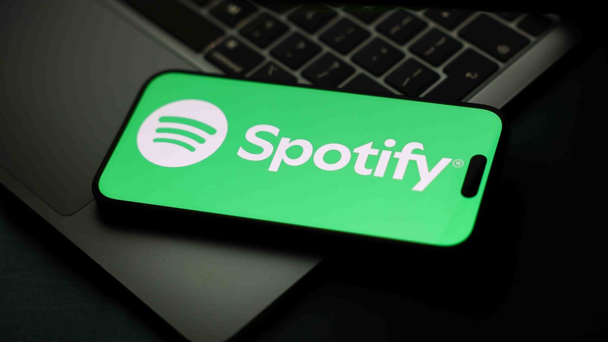 AI sign displayed on a laptop screen and Spotify logo displayed on a phone screen are seen in this illustration photo taken in Krakow, Poland on February 4, 2026. (Photo by Jakub Porzycki/NurPhoto via Getty Images)