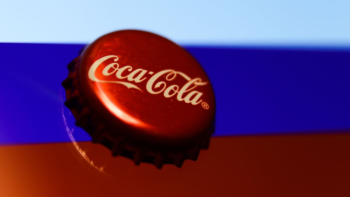 Coca-Cola cap and Russian flag displayed on a phone screen are seen in this illustration photo taken in Krakow, Poland on March 6, 2022.  (Photo illustration by Jakub Porzycki/NurPhoto via Getty Images)