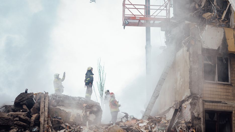 DNIPRO, UKRAINE - JANUARY 15: Firefighters are conducting search and rescue operations at residential building hit by missile on January 15, 2023 in Dnipro, Ukraine. Part of the building was completely destroyed with more than 20 victims reported. Fireman and rescuers are working at the scene of the tragedy, rescuing people from the rubble. (Photo by Denys Poliakov/Global Images Ukraine via Getty Images)