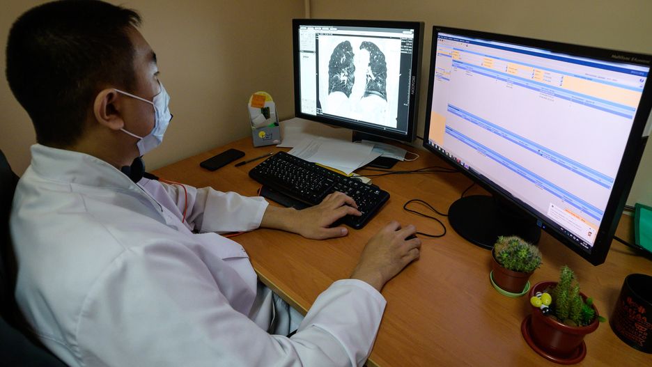 SAKHALIN REGION, RUSSIA - APRIL 7, 2020: A medical worker looks at a monitor showing a lung CT scan at a consultation outpatient clinic at the Sakhalin Region Clinical Hospital in Yuzhno-Sakhalinsk in Russia's Far East, during the pandemic of the novel coronavirus (COVID-19). To detect coronavirus infections early, a diagnostic and reference facility has been set up at the clinic, which receives and analyses lung CT scans of pneumonia patients from across Sakhalin Region. As of 7 April, Russia has reported 6,300 confirmed cases of the novel coronavirus, with 6 confirmed cases in Sakhalin Region. Sergei Krasnoukhov/TASS (Photo by Sergei Krasnoukhov\TASS via Getty Images)