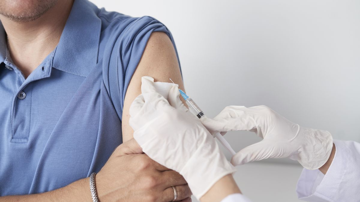 Giving injectionHands of doctor with syringe giving injection of vaccine to male patientdoctor, medicine, disease, epidemic, syringe, needle, injection, vaccine, vaccination, hands, glove, arm, patient, hospital, clinic, healthcare, hepatitis, insulin, man, pharmacy, virus, preventative, risk, procedure, treatment, placebo