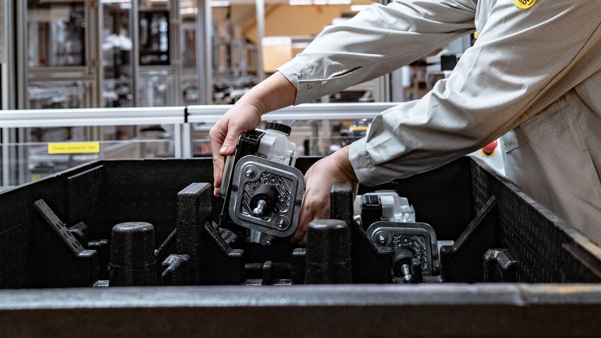 An employee places a part of an MK C2 brake system module in a container on the production line at the Continental AG manufacturing plant in Frankfurt, Germany, on Friday, March 3, 2022. The German auto supplier is scheduled to announce full year earnings on March 8. Photographer: Ben Kilb/Bloomberg via Getty Images