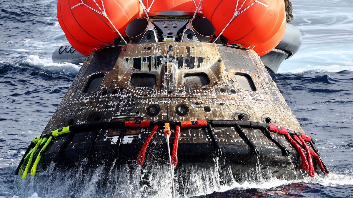 AT SEA, PACIFIC OCEAN - DECEMBER 11: NASA's Orion Capsule is drawn to the well deck of the U.S.S. Portland after it splashed down following a successful uncrewed Artemis I Moon Mission on December 11, 2022 in the Pacific Ocean off the coast of Baja California, Mexico. A 26-day mission took the Orion spacecraft to the moon and back which completed a historic test flight that coincided with the 50th anniversary of the landing of Apollo 17 on the moon, the last time that NASA astronauts walked there. (Pool photo by Mario Tama/Getty Images)