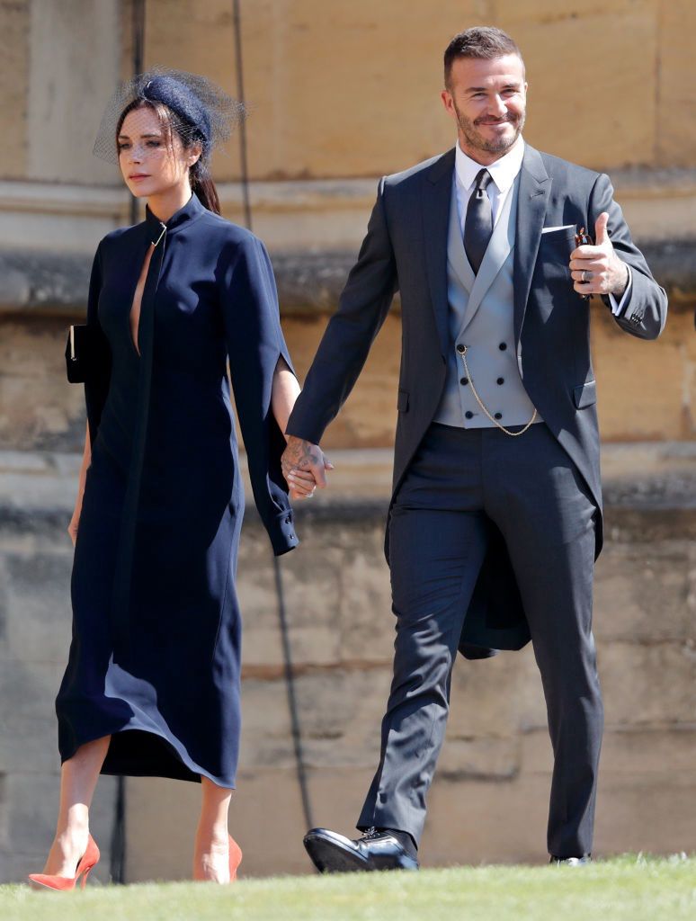 Prince Harry Marries Ms. Meghan Markle - Windsor CastleWINDSOR, UNITED KINGDOM - MAY 19: (EMBARGOED FOR PUBLICATION IN UK NEWSPAPERS UNTIL 24 HOURS AFTER CREATE DATE AND TIME) Victoria Beckham and David Beckham attend the wedding of Prince Harry to Ms Meghan Markle at St George's Chapel, Windsor Castle on May 19, 2018 in Windsor, England. Prince Henry Charles Albert David of Wales marries Ms. Meghan Markle in a service at St George's Chapel inside the grounds of Windsor Castle. Among the guests were 2200 members of the public, the royal family and Ms. Markle's Mother Doria Ragland. (Photo by Max Mumby/Indigo/Getty Images)Max Mumby/Indigoroyal family, royals, windsor, morning suit, smile, thumb up, gesture hand gesture, hand in hand