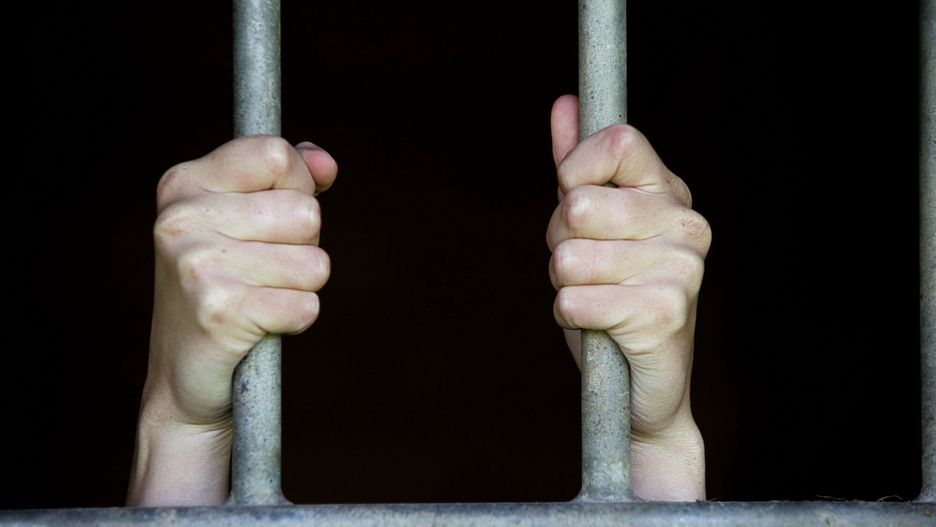 Stock picturesPHOTO:EAST NEWS/ ISOPIX/Hands of a man fixed on the bars of a gate. Credit Etienne Ansotte / ISOPIX    **** REFERENCE : 00026809 ****