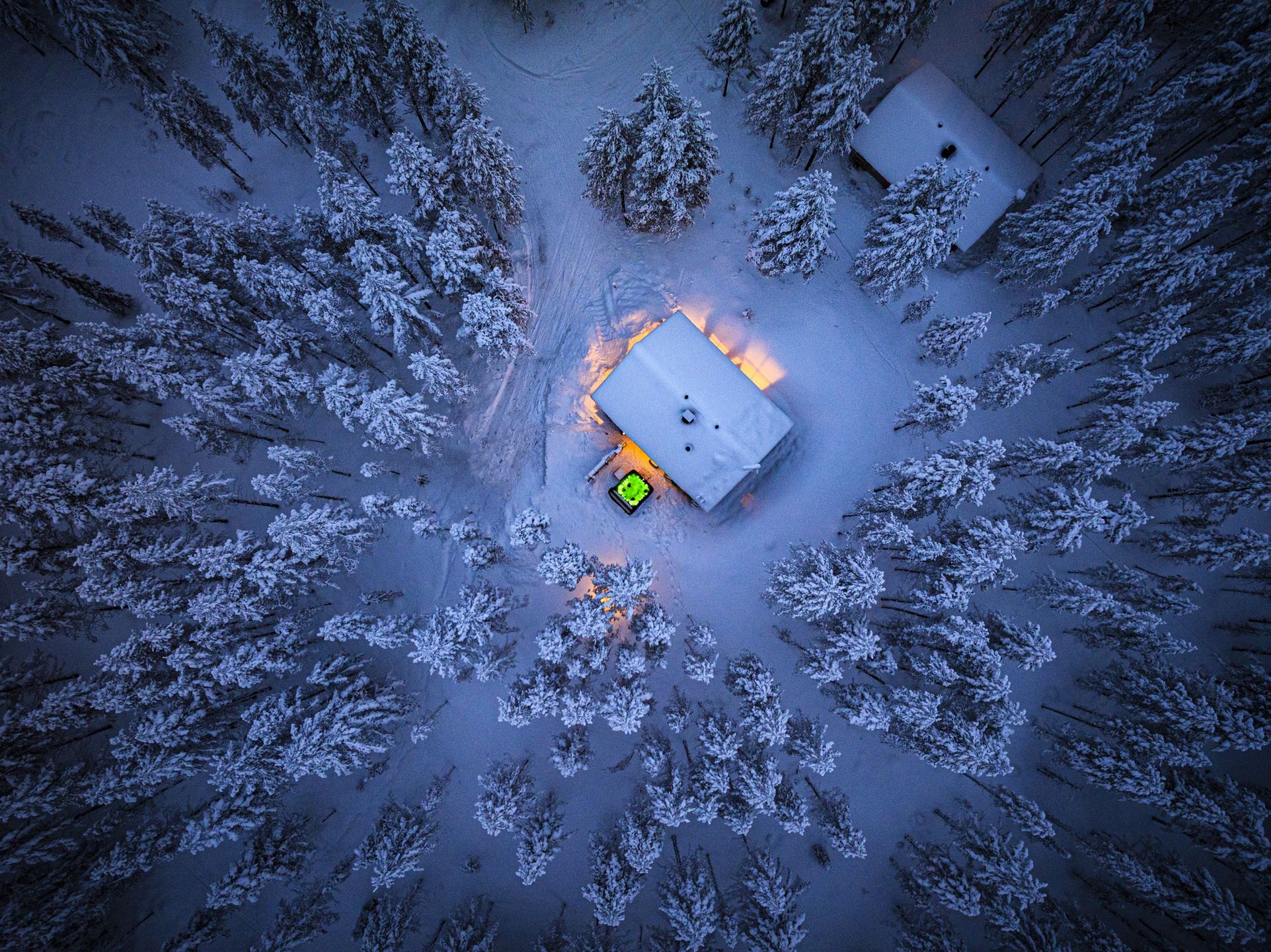 Cottage with hot tub in a snowy forest at dusk, aerial view
Overhead view of a rustic cottage with outdoors hot tub in the middle of a frozen snowy forest at dusk, Lapland, Finland
Roberto Moiola / Sysaworld