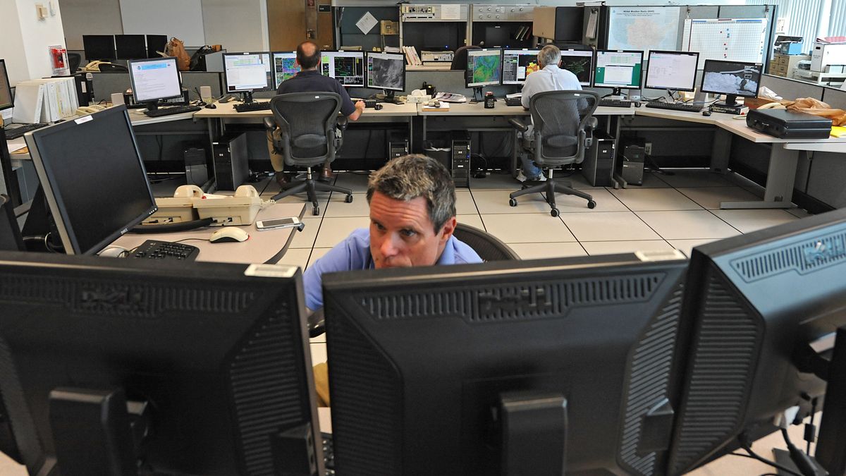 Meteorologists Brian Montgomery, left, Hugh Johnson, center, and George Maglaras watch computer screens at the National Oceanic Atmospheric Administration (NOAA ) National Weather Service forecast office on Tuesday, Sept. 22, 2015 in Albany, N.Y. (Photo by Lori Van Buren/Albany Times Union via Getty Images)