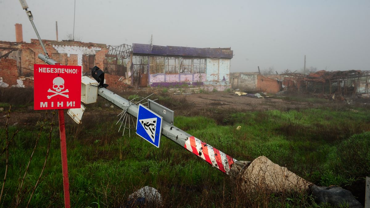KAMENKA, UKRAINE – APRIL 24: A sign with the inscription "Danger, mines" stands installed next to a store destroyed by shelling on April 24, 2023 in Kamenka Village, Izyum Raion, Kharkiv Oblast, Ukraine. During the Russian invasion and future liberation by the Ukrainian army, Izyum and its raion (disstrict) were subjected to artillery and missile attacks every day, resulting in the destruction of more than half of the city. (Photo by Eugene Hertnier/Global Images Ukraine via Getty Images)