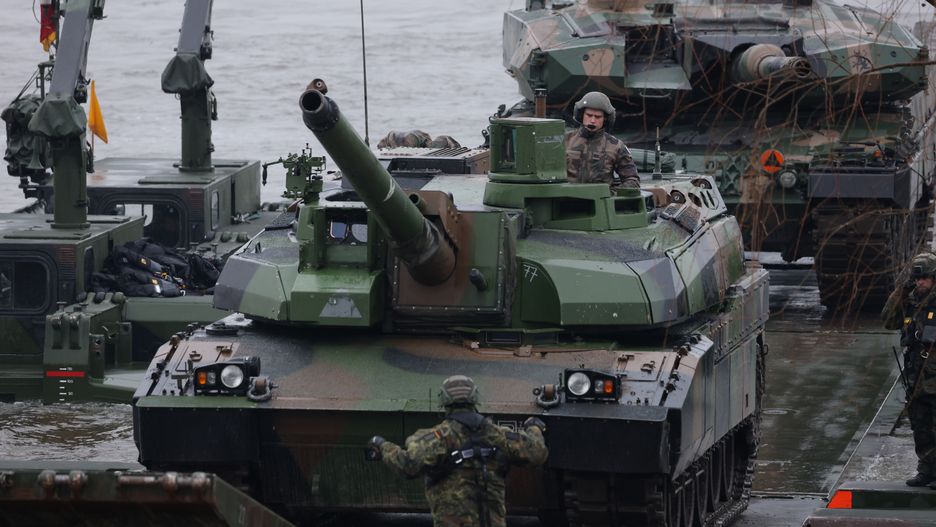 GNIEW, POLAND - MARCH 05: A French Leclerc (L) and a Polish Leopard 2PL main battle tanks arrive on M3 amphibious rigs of the German/British Amphibious Engineer Battalion 130 after crossing the Vistula River during the NATO Dragon 24 military exercise on March 05, 2024 near Gniew, Poland. Dragon 24 is involving troops from 10 different nations and is part of Steadfast Defender, an ongoing set of NATO military manoeuvres across Europe that is involving 90,000 troops. (Photo by Sean Gallup/Getty Images)