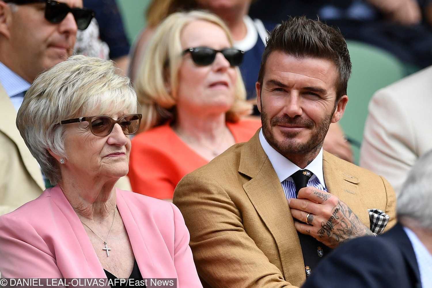 Former England footballer David Beckham (R) sits in the Royal Box with his mother Sandra Georgina West (L) above Centre Court as Ukraine's Elina Svitolina plays  against Romania's Simona Halep during their women's singles semi-final match on day ten of the 2019 Wimbledon Championships at The All England Lawn Tennis Club in Wimbledon, southwest London, on July 11, 2019. (Photo by Daniel LEAL-OLIVAS / AFP) / RESTRICTED TO EDITORIAL USE