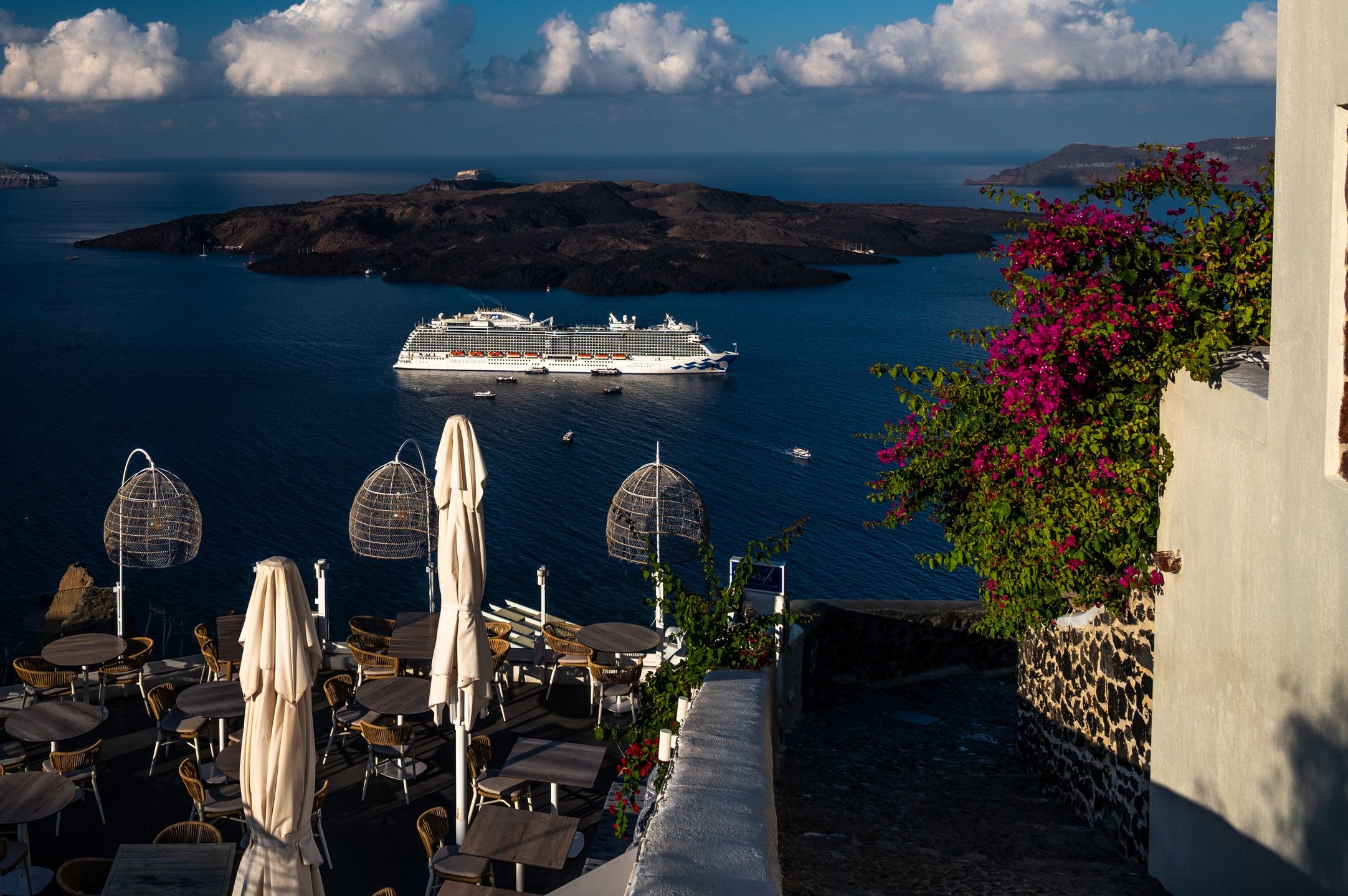SANTORINI, GREECE - 2022/10/09: Cruise ships are seen arriving in Santorini with tourists. Santorini is one of the Cyclades islands in the Aegean Sea known for the traditional architecture of the whitewashed buildings, making it one of the most famous travel destinations during summer in the Mediterranean. (Photo by Marcos del Mazo/LightRocket via Getty Images)