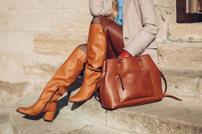 Close up of woman wearing stylish orange boots leather skirt holding purse outdoors. Spring fashion accessories clothesClose up of woman wearing stylish orange boots leather skirt beige coat holding purse outdoors. Spring fashion accessories clothes. Classic outfitNedopekin Yuriyfashion, shoes, boots, accessories, woman, female, handbag, purse, bag, spring, city, street, coat, skirt, leather, outdoors, outfit, stylish, legs, autumn, fall, clothes, clothing, girl, orange, brown, gloves, beige, young, people, blue, urban, beautiful, luxury, retro, style, retro-styled, elegant, extravagant, caucasian, elegance, glamour, lifestyles, holding, modern, sweater, stairs, close up, caramel