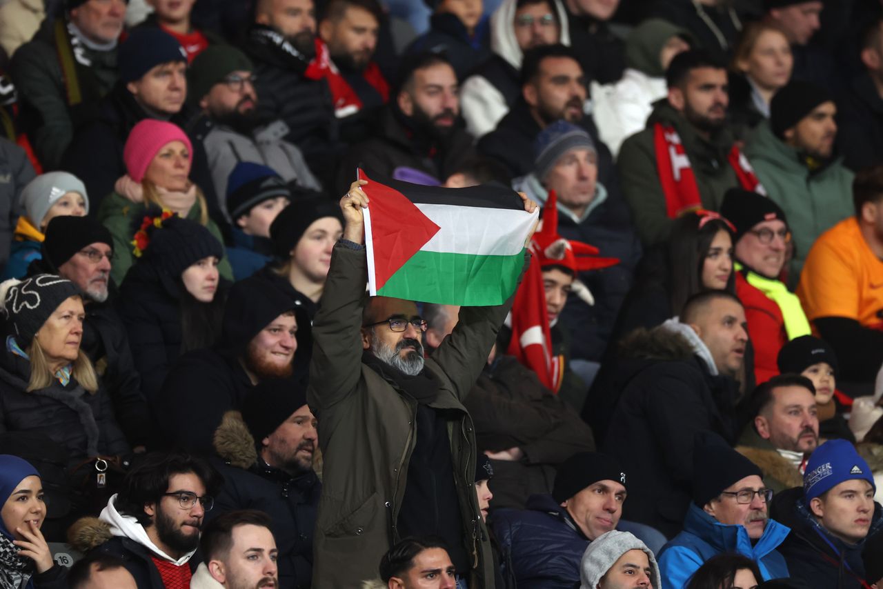 BERLIN, GERMANY - NOVEMBER 18: A man holds up a Palestine flag during an international friendly match between Germany and Turkey at Olympiastadion on November 18, 2023 in Berlin, Germany. (Photo by Alex Grimm/Getty Images)