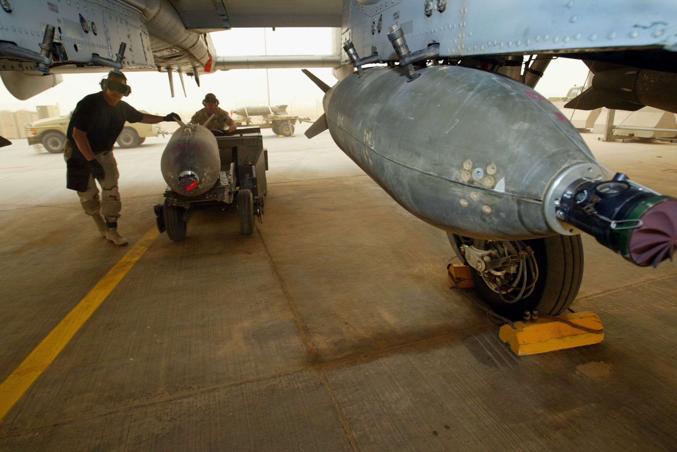 U.S. Air Force Waits For Flight Conditions To Improve
AIR BASE, KUWAIT - MARCH 27:  A U.S. Air Force weapons unit moves a 500 lb Guided Bomb (G.B.U) onto an A-10 fighter March 27, 2003 on an air base in Kuwait. Flights were delayed in the afternoon for a second day due to poor visability as Operation Iraqi Freedom continues with a strategic air campaign.  (Photo by Paula Bronstein/Getty Images)
Paula Bronstein
A- 10 wind sky skies sand storm plane jet Iraq conflict Air base