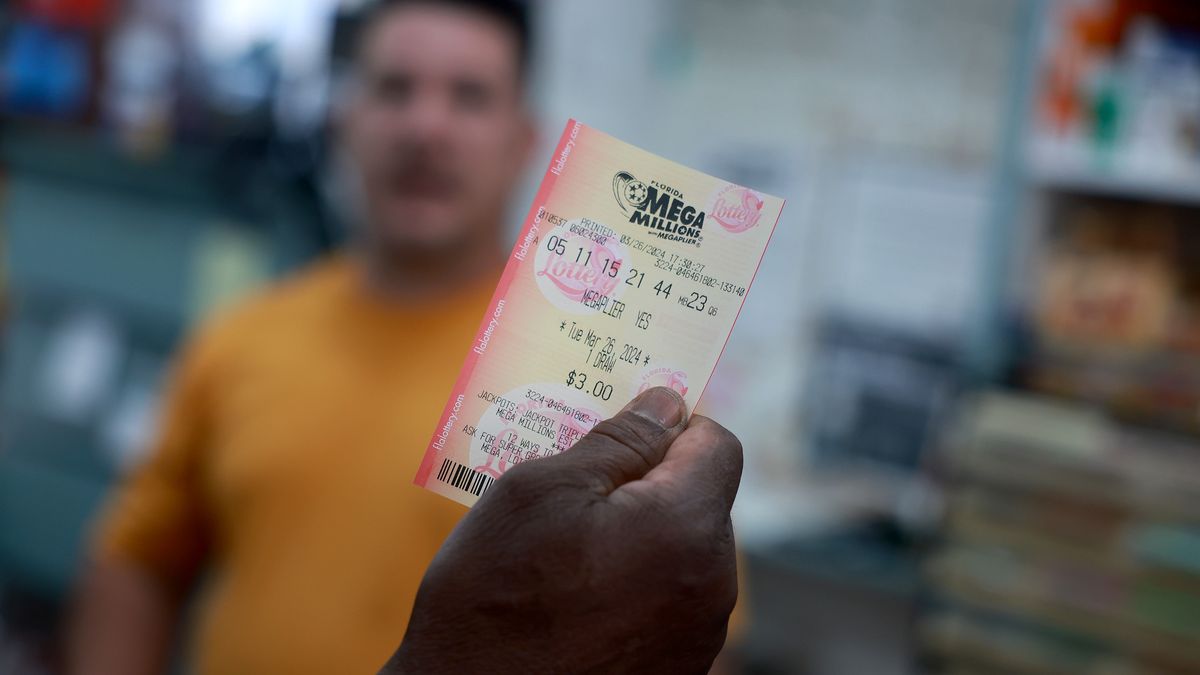 MIAMI, FLORIDA - MARCH 26: A customer purchases a Mega Million lottery ticket at the La Esquina Tropical supermarket on March 26, 2024 in Miami, Florida. The Mega Millions jackpot has reached $1.13 billion for tonight's drawing.  (Photo Joe Raedle/Getty Images)
