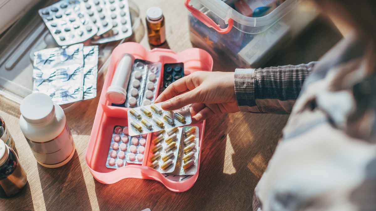 Closeup female hand neatly placing medicament at domestic first aid kit top view. Storage organization in transparent plastic box drug, pill, syringe, bandage. Fast health help safety emergency supply
Kseniya Ovchinnikova