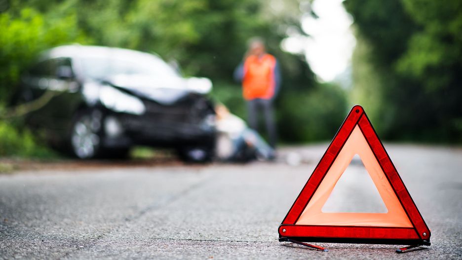 A close up of a red emergency triangle on the road in front of a car after an accident.
A close up of a red emergency triangle on the road in front of a damaged car and unrecognizable people. A car accident concept. Copy space.
adult, outside, outdoors, countryside, road, trees, car, accident, damaged, automobile, vehicle, after, dangerous, danger, safety, claim, crash, insurance, collision, driver, damage, wreck, transport, emergency, hit, broken, man, injured, people, close-up, copy, space, triangle, red, background, blurred, closeup, close up, empty, blank, vest, reflexive, rescue