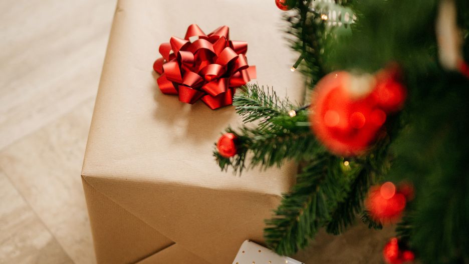 Two christmas gifts under the christmas tree. No people. Horizontal